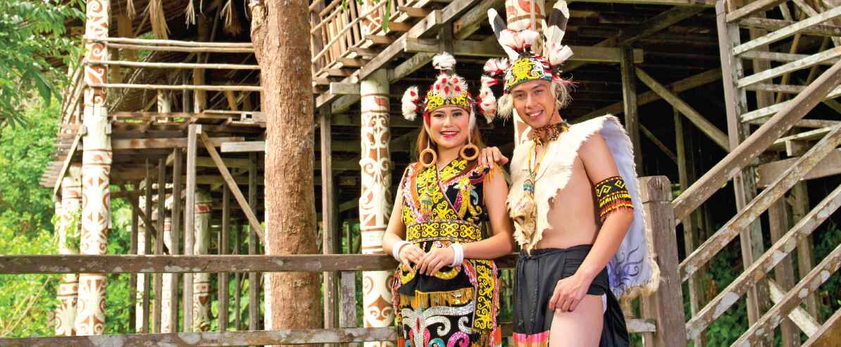 2 people wearing their ethnic outfit at Sarawak Cultural Village