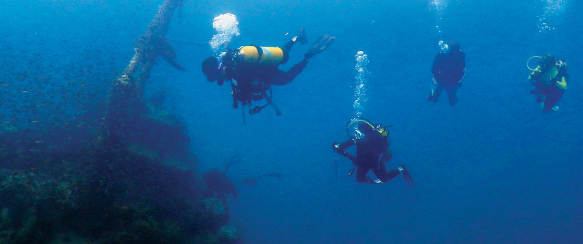 Scuba divers exploring the depths near Pulau Satang and Kuching,